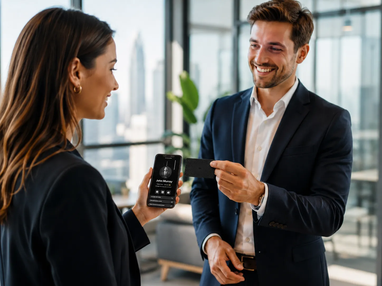 Sales rep sharing a Banana NFC business card with a prospect who instantly receives the digital contact profile on their phone
